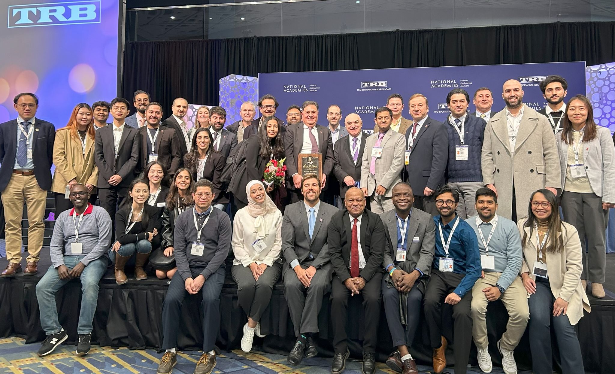 Osman, bottom row fifth from the right, smiles at an award ceremony for&amp;nbsp;Al-Qadi, who received the Roy W. Crum Distinguished Service Award at the Transportation Research Board on January 10, 2024.