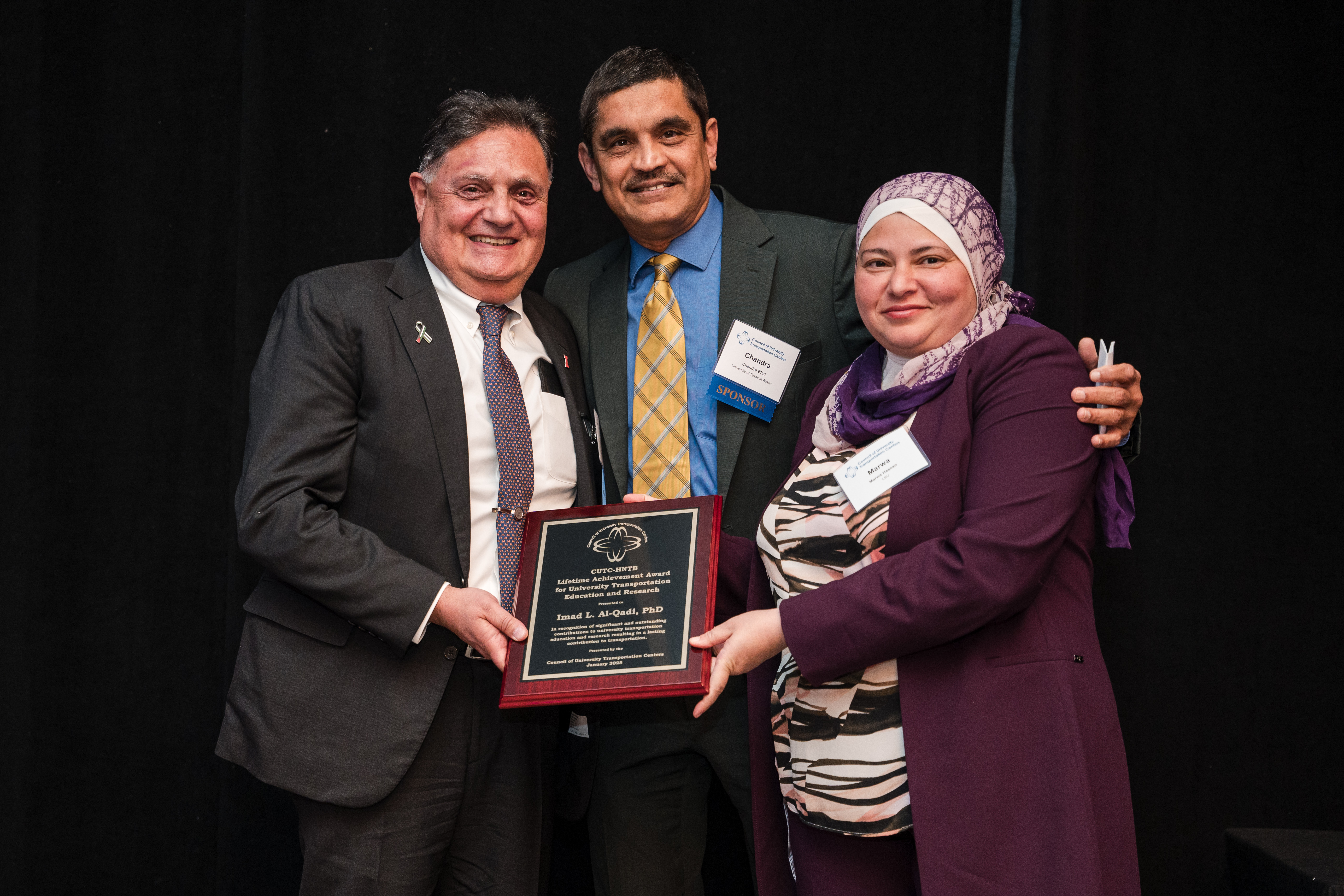 From left: Al-Qadi smiling with Chandra Bhat, Joe J. King Chair in Engineering at the University of Texas at Austin, and Marwa Hassan, CUTC president, at the award ceremony in Washington, D.C. on Jan. 4.