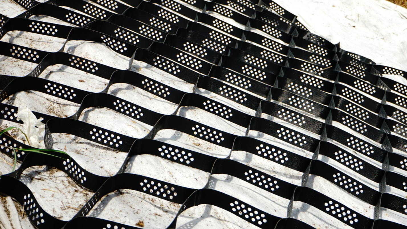 Geosynthetics are synthetic polymer materials that help stabilize and strengthen weak soil foundations.