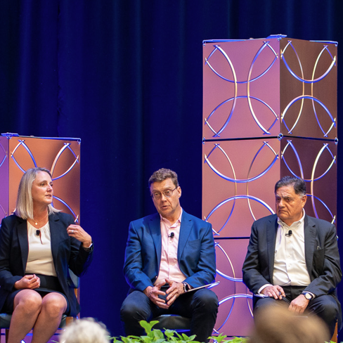 A group of people sitting on a stage.