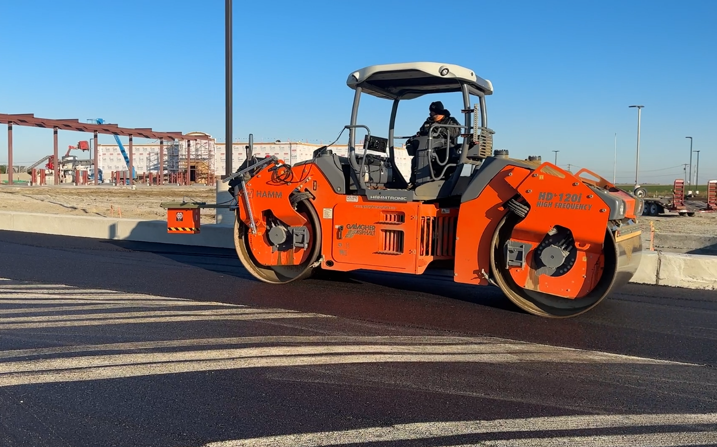 A roller compactor with a ground-penetrating radar attached to the front.