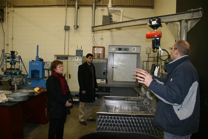 Illinois State University Faculty and Staff Kathy Young, Director of Research and Sponsored Programs (left) and Dr. Pranshoo Solanski, Assistant Professor of Construction Management (right) get a tour from Senior Research Engineer Aaron Coenen. Marissa McCord, Associate Director of Government Relations, also toured the facility.