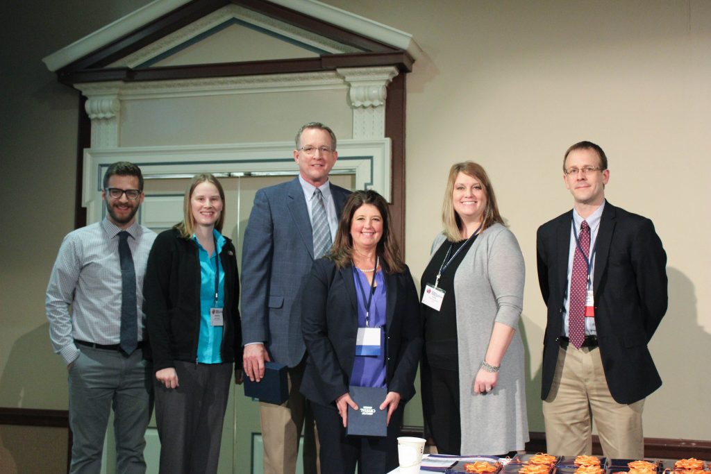 Schattler, fourth from left, was all smiles during the presentation of awards, where she earned T. H. E.&rsquo;s High-impact Project of the Year.