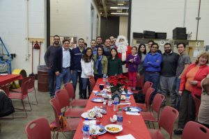 Students pose with Santa Claus at the Transportation Group Winter Open House.