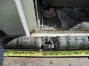 Shale core sample opened for logging and packaging at an IDOT bridge site showing weak and disturbed shale.