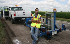 Issam Qamhia poses with a falling-weight deflectometer.