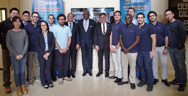 ICT student researchers, UIUC Grainger College of Engineering Dean Rashid Bashir, UIUC Chancellor Robert Jones, and ICT Director Imad Al-Qadi come together to discuss the Smart Transportation Infrastructure Initiative.