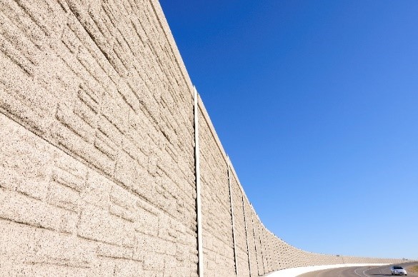 Stone noise barrier along the interstate.