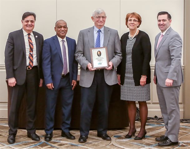 UIUC Professor Emeritus Marshall Thompson, center, was all smiles after IAPA recognized his major contributions to the asphalt paving industry during the 82<sup>nd</sup> annual IAPA meeting earlier in March, launching an endowed professorship in Thompson&rsquo;s name. Alongside Thompson are (from left): ICT Director Imad Al-Qadi, IDOT Secretary Omer Osman, President and CEO of the National Academy of Construction Anne Bigane Wilson, and IAPA Executive Vice President Kevin Burke III.