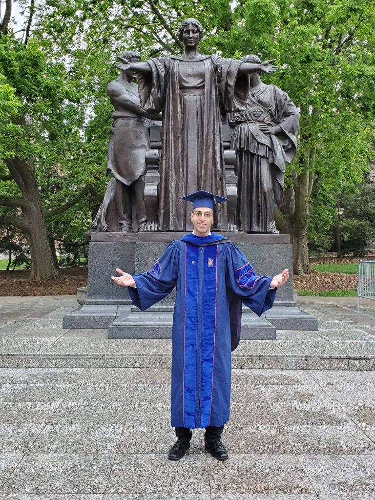 Issam Qamhia poses with Alma Mater following commencement earlier in May.