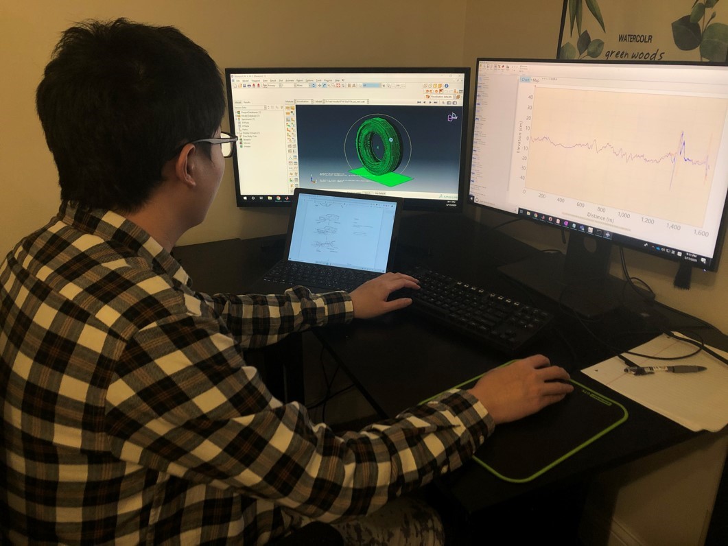 Xiuyu Liu works on numerical analysis of vehicle-road interaction from his desk at home.