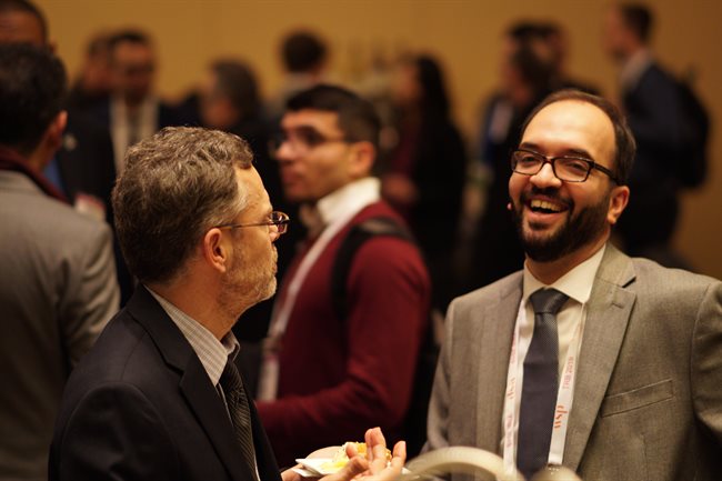 Hadi Meidani, right, a UIUC CEE assistant professor, was all smiles during the 2019 Transportation Research Board Conference in Washington, D.C.