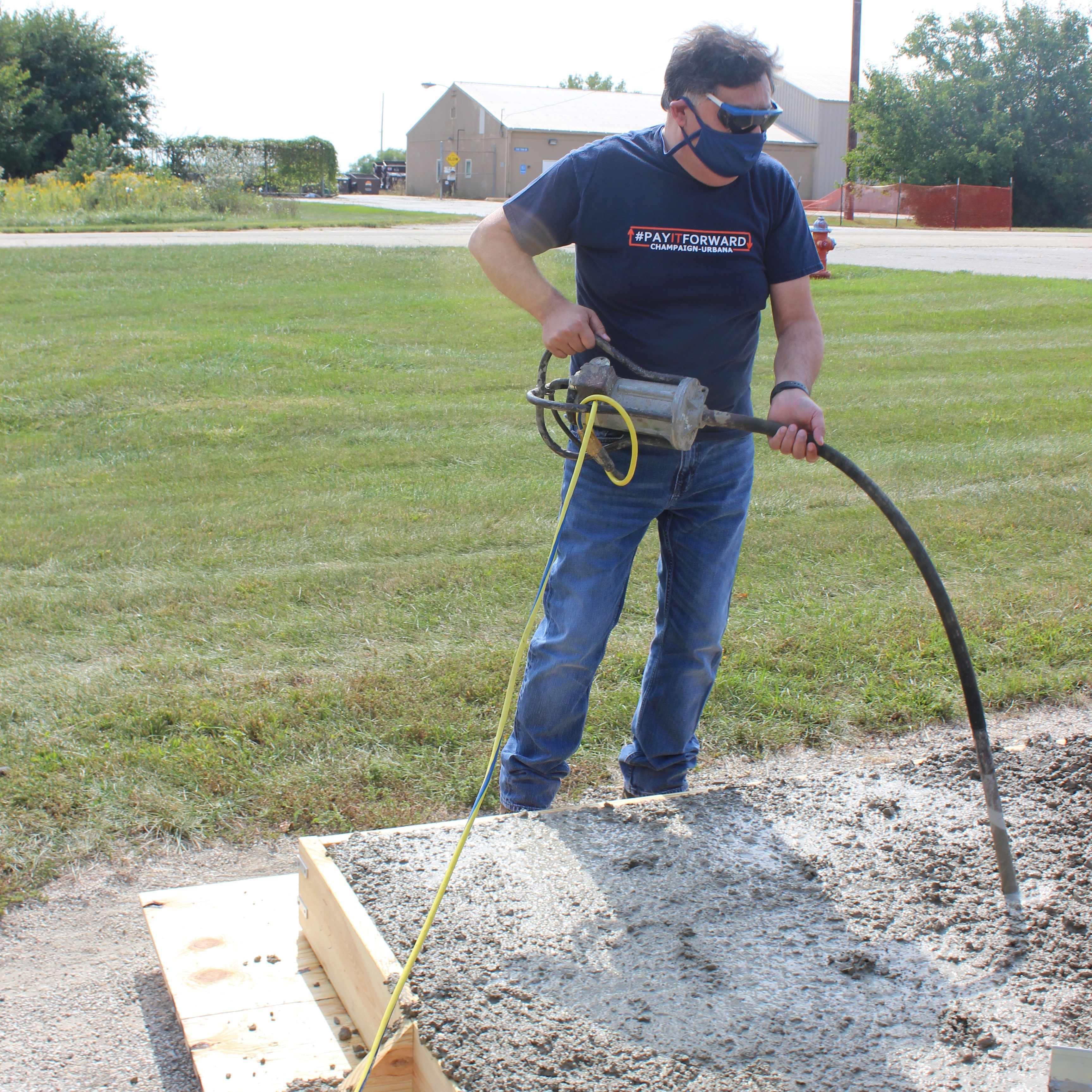 Imad Al-Qadi, left, Illinois Center for Transportation&rsquo;s director and UIUC&rsquo;s Bliss Professor of Engineering, works alongside UIUC graduate students behind the Advanced Transportation Research and Engineering Laboratory at Illinois Center for Transportation in Rantoul, IL. on Sept. 22. Here UIUC grad students prep 15 concrete test slabs for an Illinois Department of Transportation-sponsored project researching optimum hot-mix asphalt lift configurations, which aims to reduce the effects of reflective cracking on existing pavement.&nbsp;