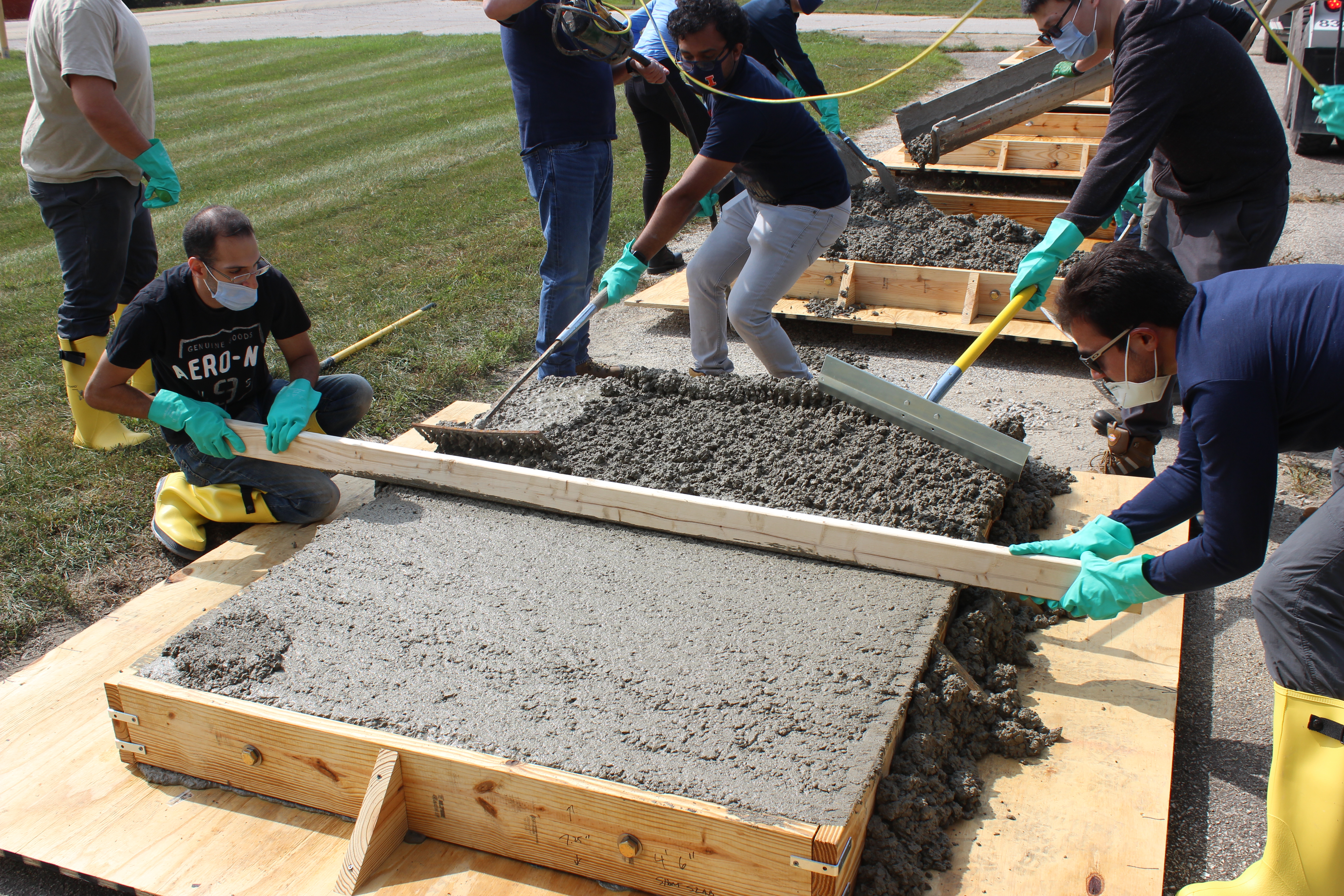 CEE grad students, from left, Issam Qamhia, Aravind Ramakrishnan, Siqi Wang and Jos&eacute; Rivera-Perez work together at ICT to even the concrete slab for the IDOT-sponsored project on Sept 22.