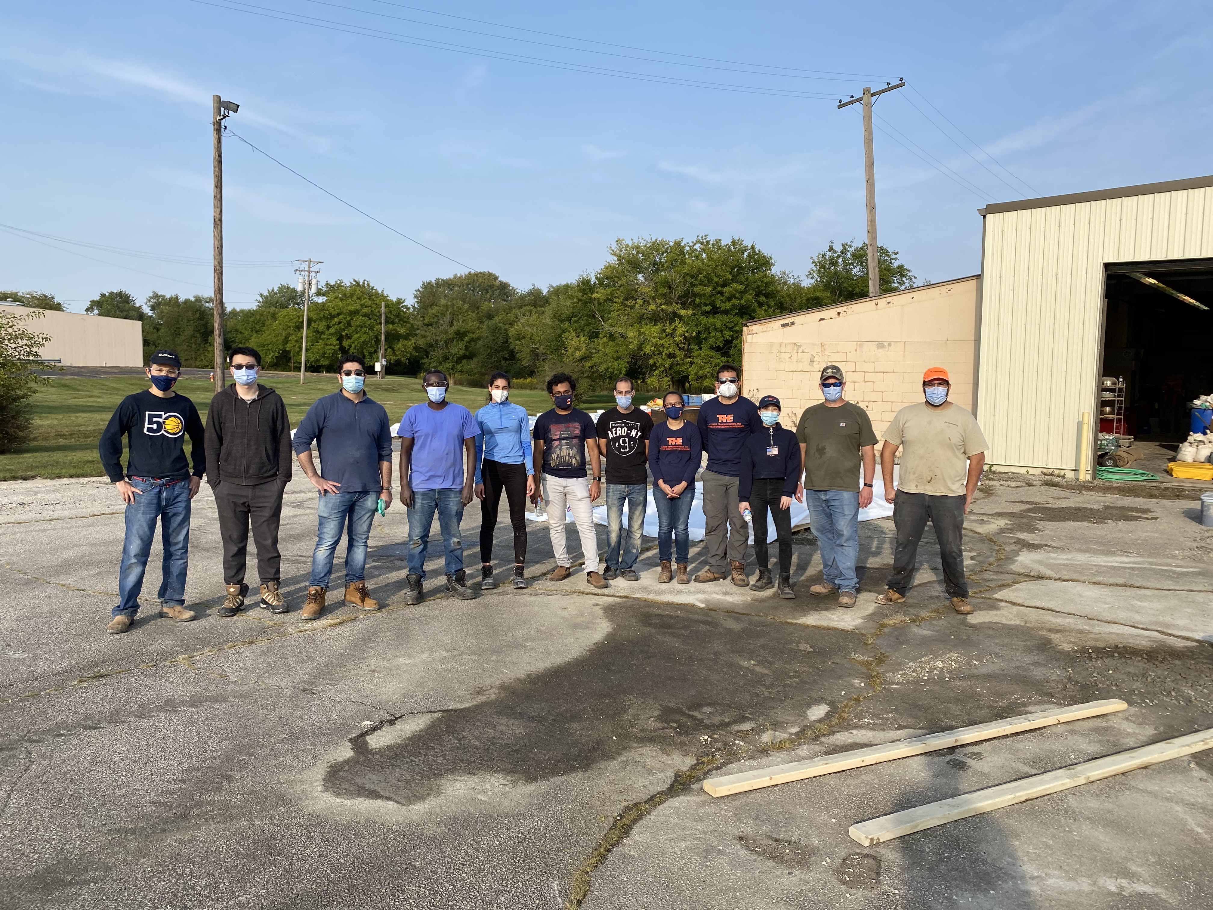 CEE graduate students strike a pose after their hard work pouring concrete into slabs for the IDOT-sponsored project held at ICT on Sept. 22.