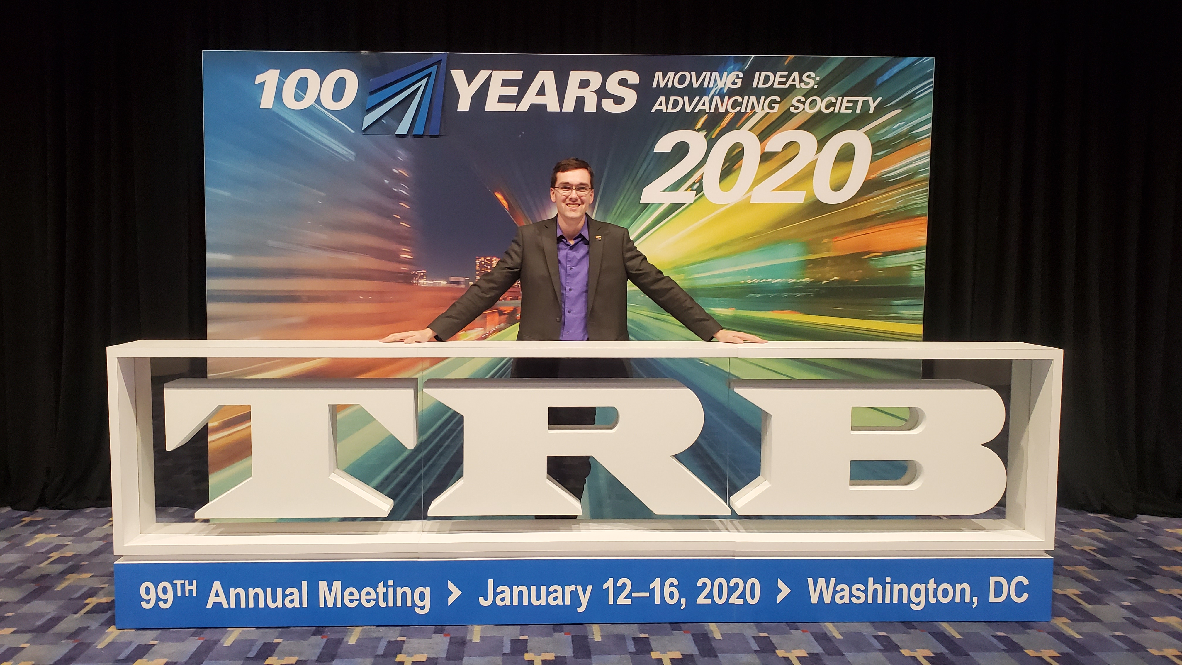 Leonel Evans, a UIUC master&rsquo;s grad, poses in front of the Transportation Research Board sign at the 99th annual meeting held in Washington, D.C. earlier in January.