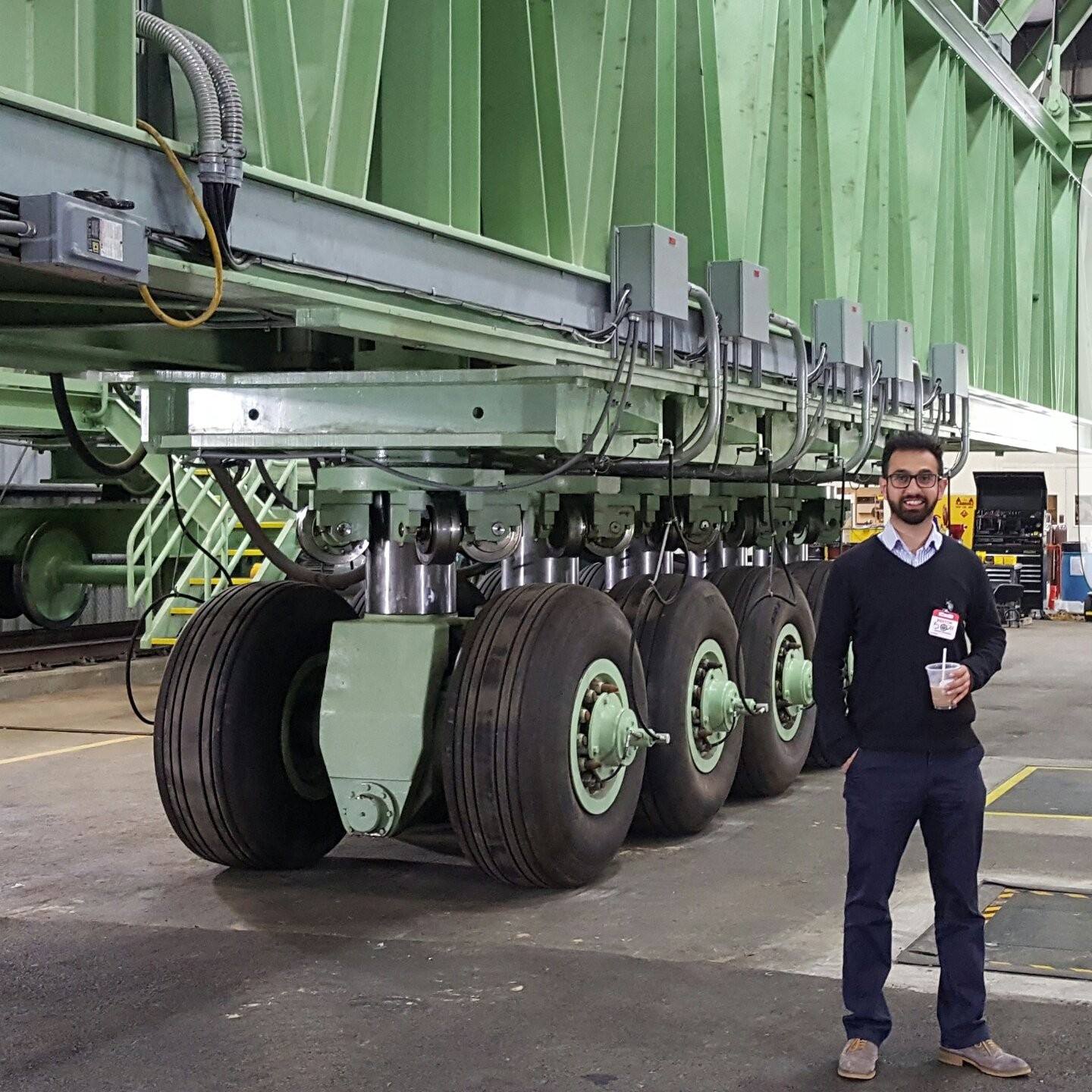Erman Gungor, a UIUC doctoral grad, poses in front of one of the largest load simulators for aircraft loading at the Federal Aviation Administration&rsquo;s National Airport Pavement Test Facility near Atlantic City, New Jersey.