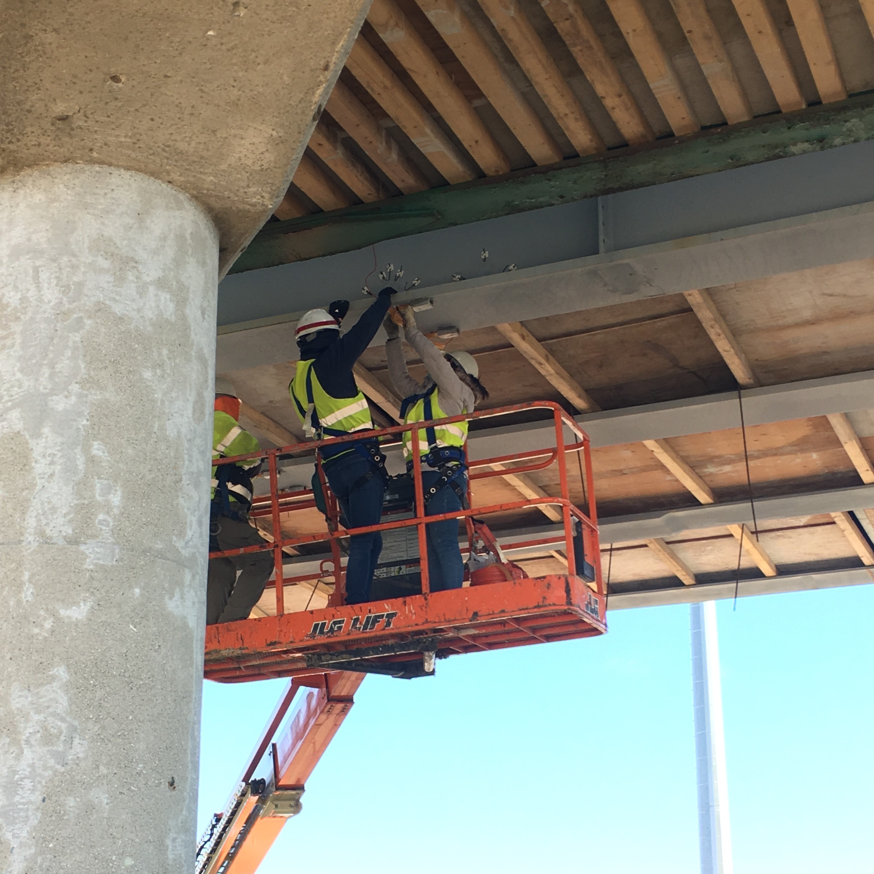 Provided by Larry Fahnestock. Sunny Zhou and Jared Motley, UIUC graduate and undergraduate students, respectively, install strain gauges on a girder at Mattis Avenue Bridge over I-57 in Champaign, Illinois, on Dec. 1, 2020. Construction of the Mattis Avenue bridges over I-57 and I-74 is estimated to be complete by August 2021.