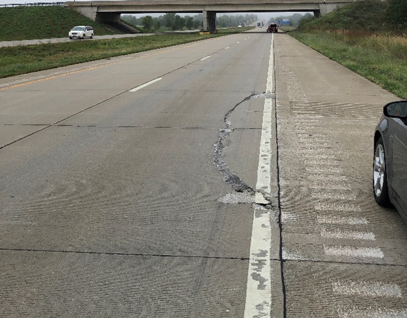Edge failures in a jointed plain concrete pavement due to lack of support.