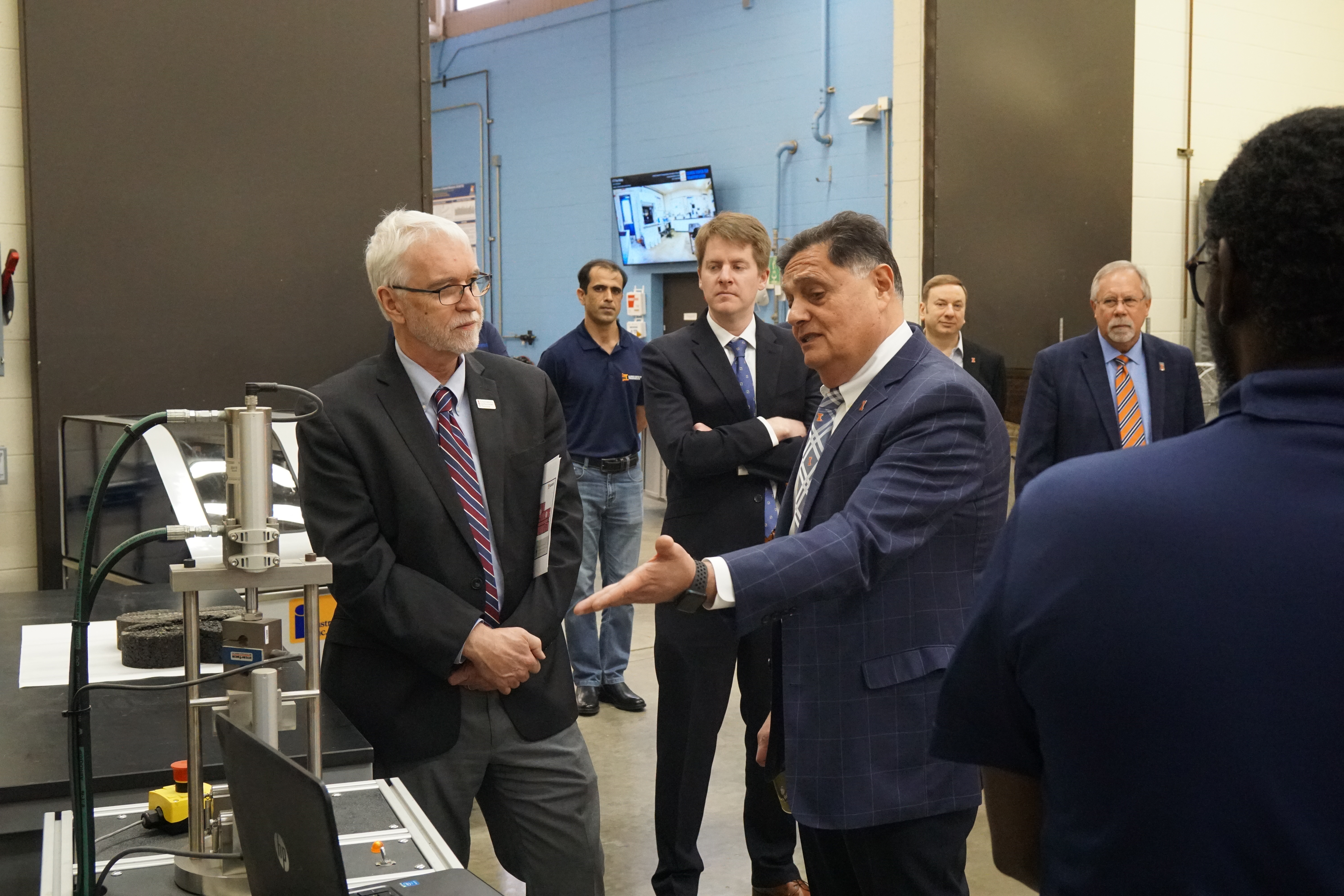 Imad Al-Qadi, Illinois Center for Transportation director and University of Illinois Urbana-Champaign Bliss Professor of Engineering, shows President Killeen the Illinois Flexibility Index Test. Developed by ICT researchers, I-FIT can predict the cracking potential of hot-mix asphalt materials.
