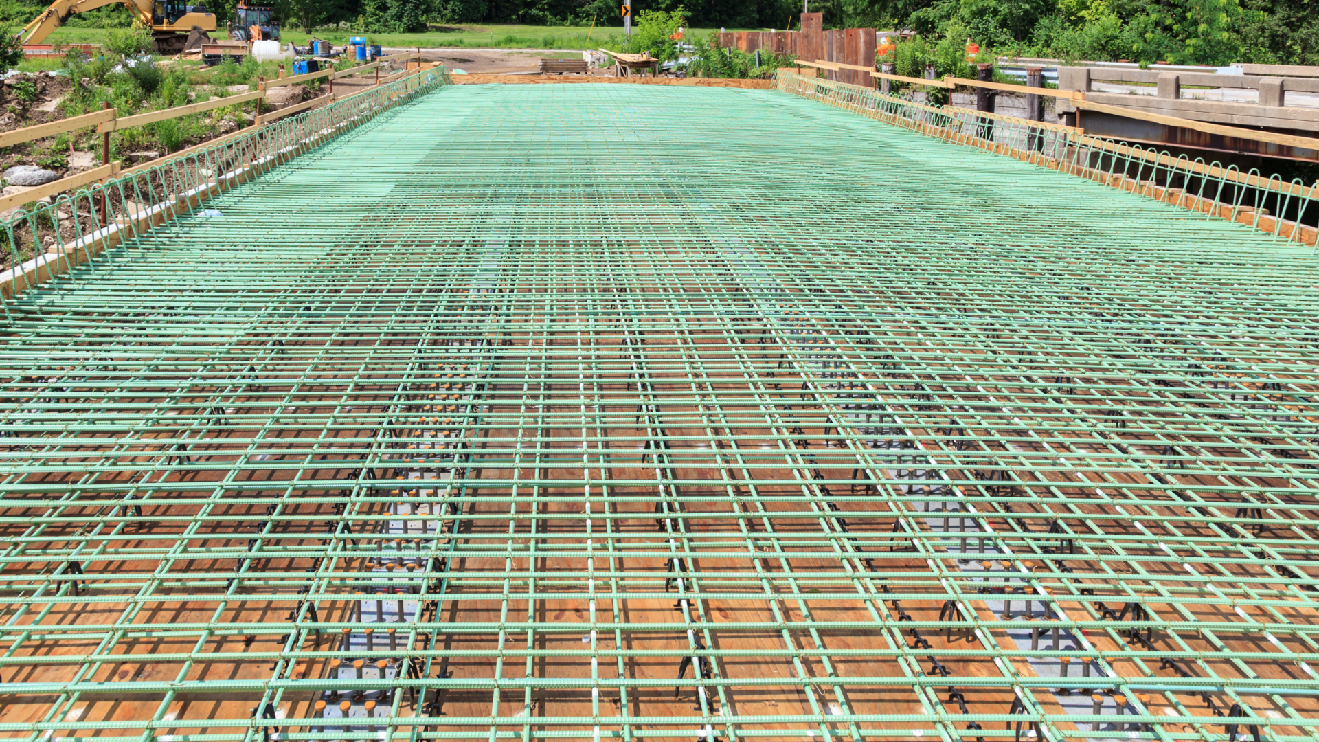 Placing epoxy-coated steel reinforcing bars in concrete bridge decks, shown above, is a popular method to help mitigate corrosion. Alternative options to prevent corrosion include the use of galvanized, stainless-steel or A1035 bars.