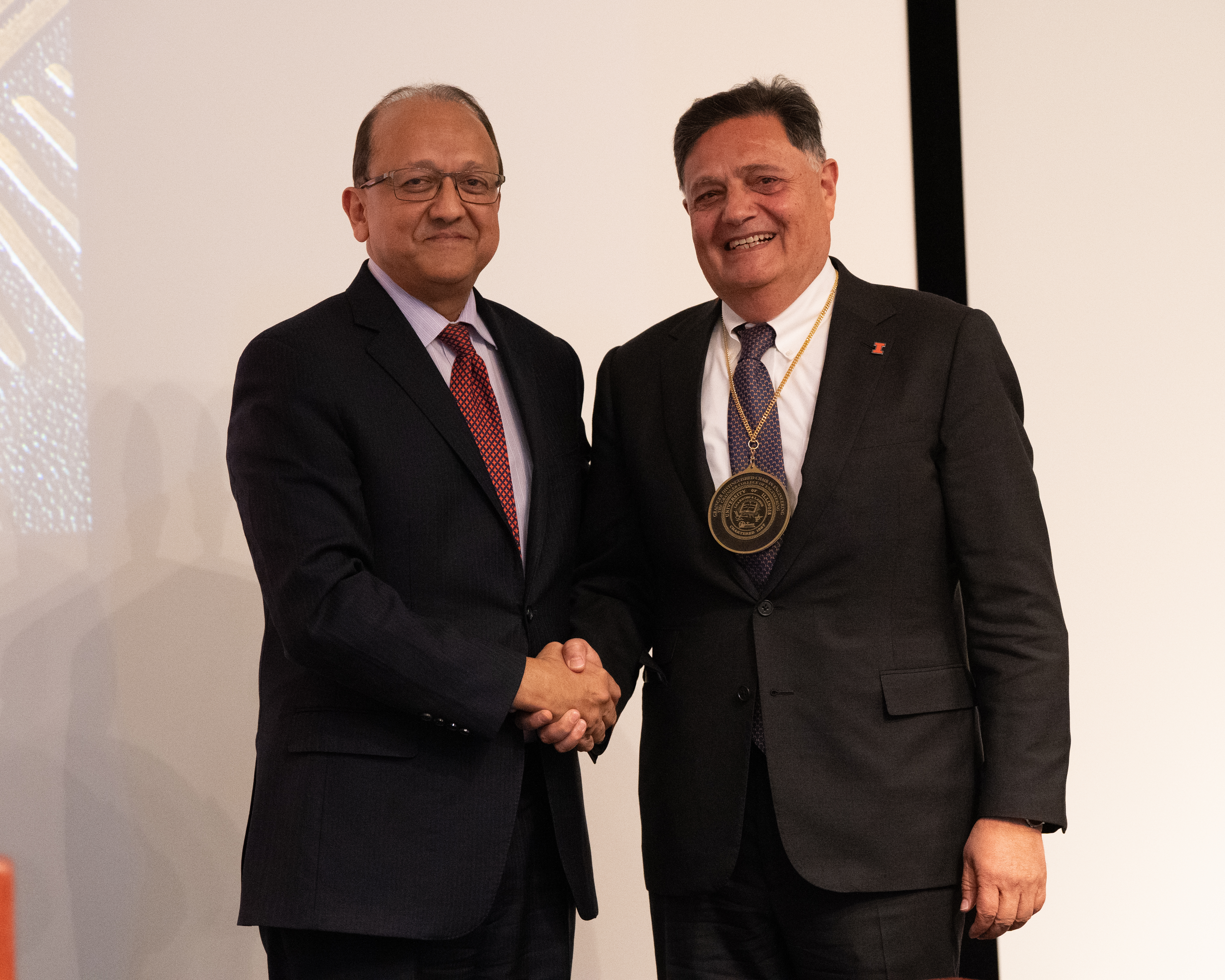 Imad Al-Qadi receives a medal from Rashid Bashir, dean of The Grainger College of Engineering, during his investiture ceremony.