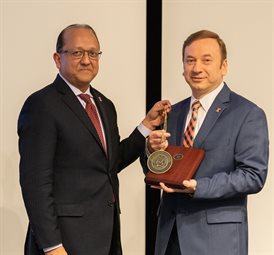 Rashid Bashir, dean of The Grainger College Engineering, presents Erol Tutumluer with his investiture medallion.