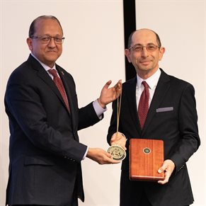 Youssef Hashash receives his investiture medallion from Dean Bashir.