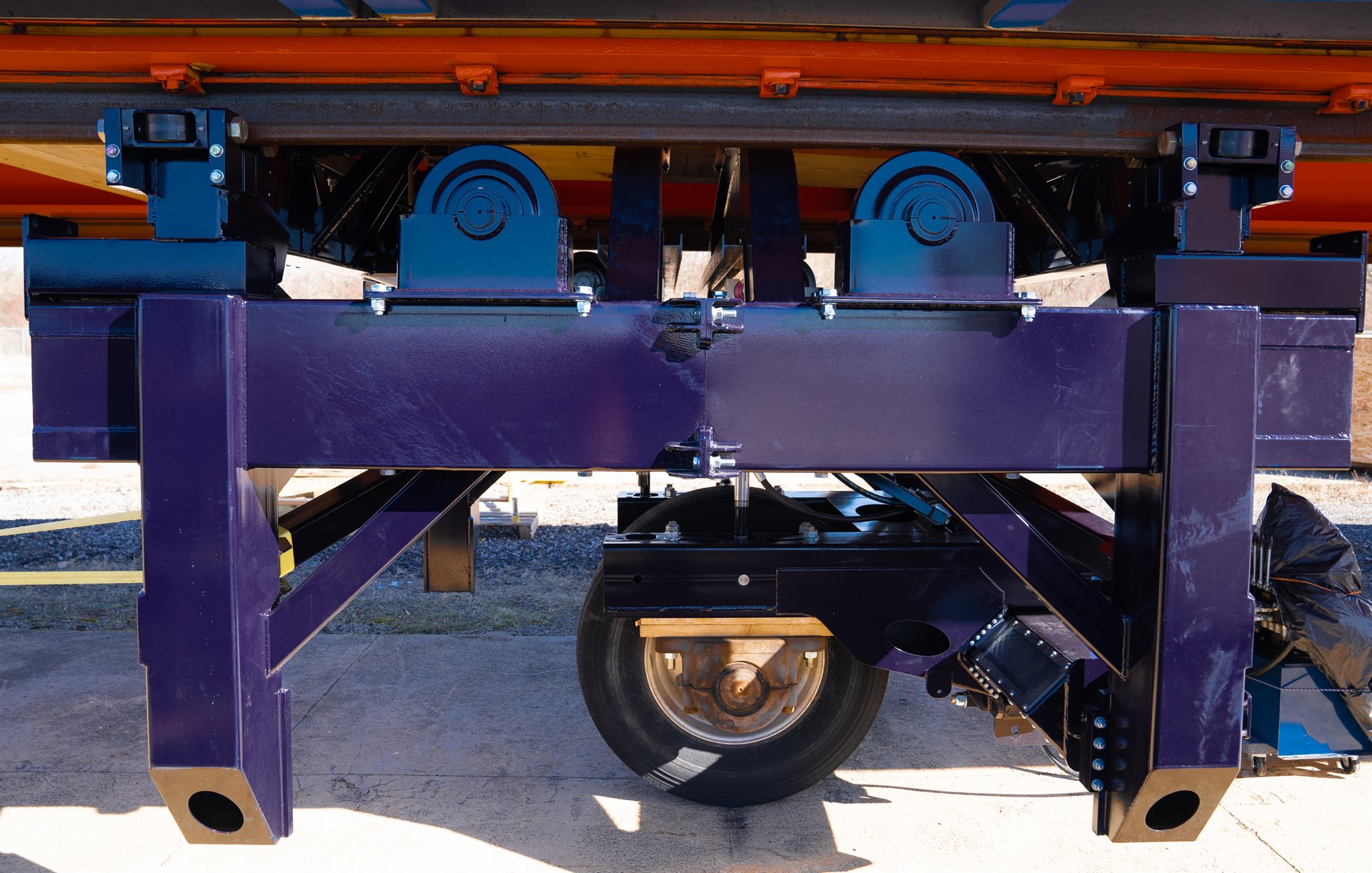 A side view of the enhanced load carriage. The upgraded design allows testing with single or tandem axles, breaking and acceleration, and axle yaw up to 6 degrees.