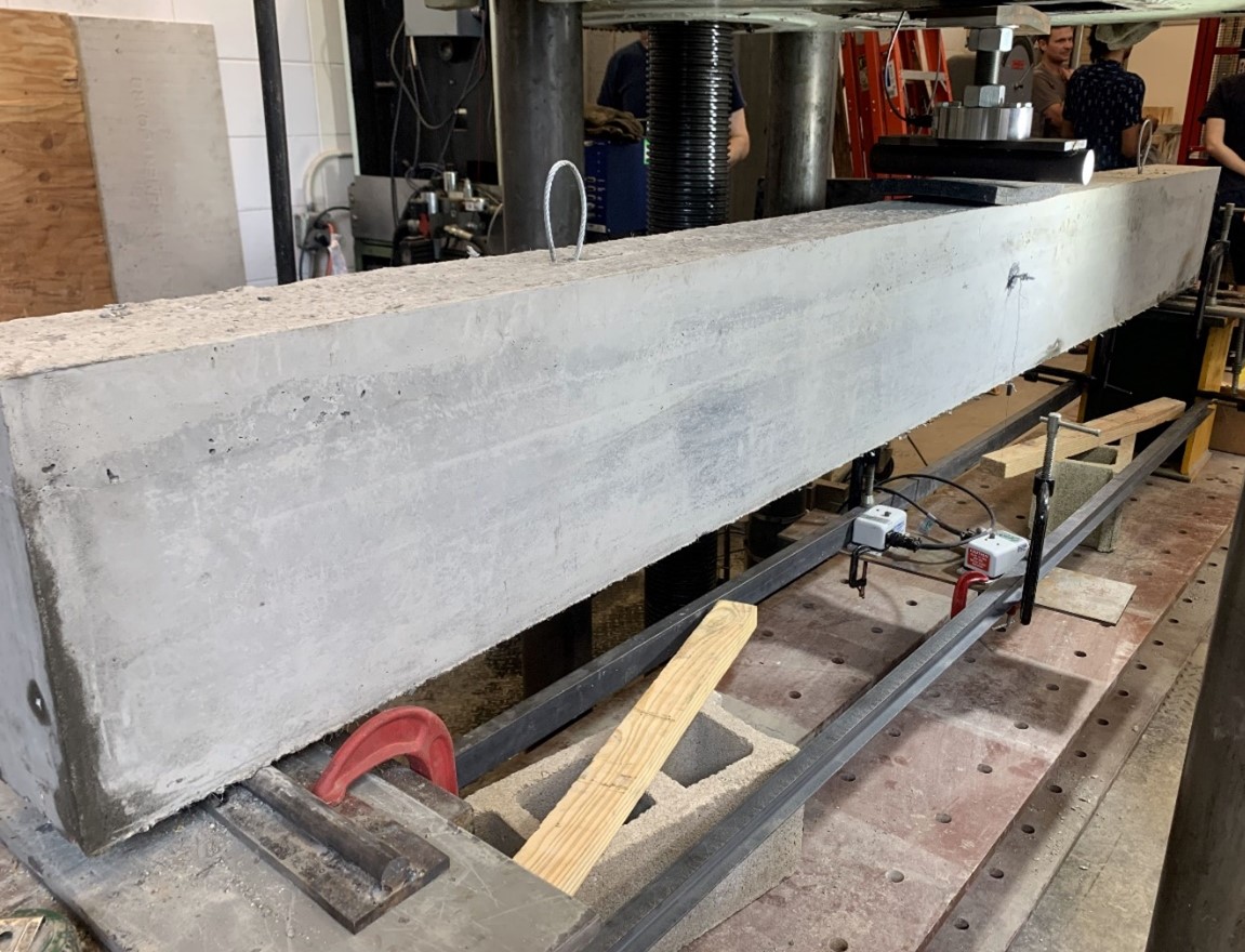 Provided by&amp;nbsp;Nishant Garg. A photo of the three-point bending test setup for a beam made with ultra-high-performance concrete. Regular concrete has a strength of around 4,000 to 6,000 psi, while the strength of UHPC ranges from 18,000 to 21,000 psi.